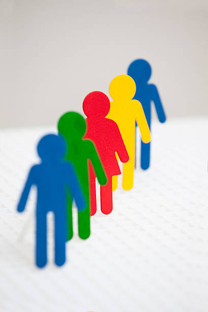 istock Four males and one female figures in a line. 527167821