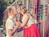 Young couple kissing on the railway station