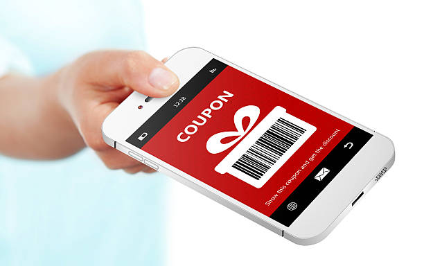 istock hand holding mobile phone with christmas coupon over white 527170347