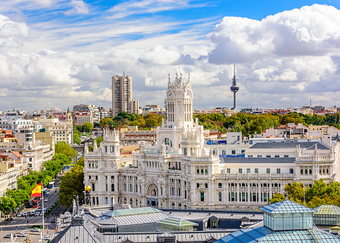 Gran Via street view, Madrid, Spain. Crowd of people at Callao Square and many cars in the street.