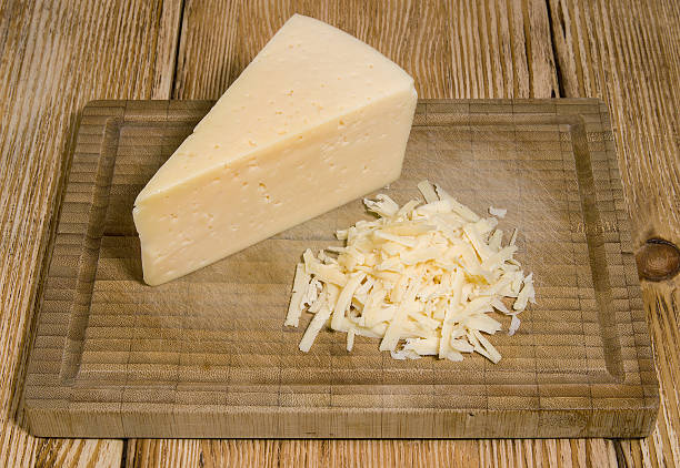 istock Shredded cheese and a piece of cheese 527209288