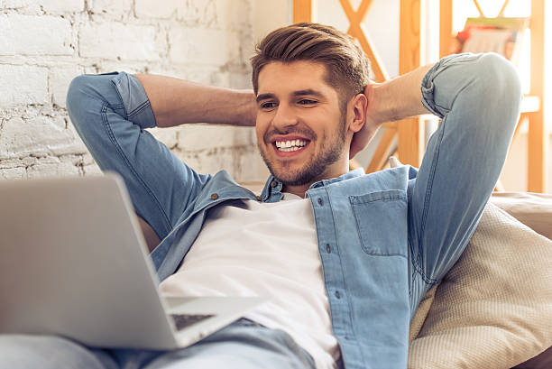 istock Young man with gadget at home 527209614