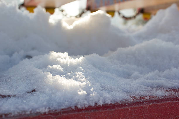 istock Snow closeup on a red wooden background 527210026