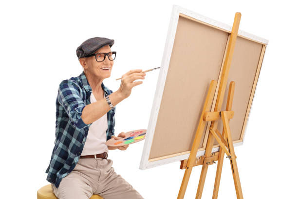 istock Senior artist painting on a canvas 527210388