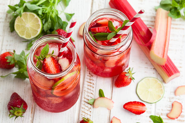 strawberry,lime and rhubarb lemonade Preparation homemade refreshing  strawberry,lime and rhubarb lemonade with mint rhubarb photos stock pictures, royalty-free photos & images