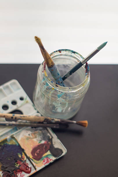 istock artist's palette, brushes and water jar 527215118