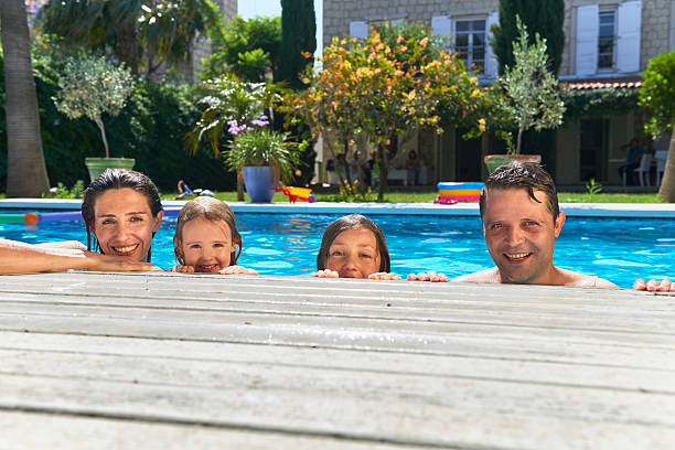 istock Family holding to poolside 527218734