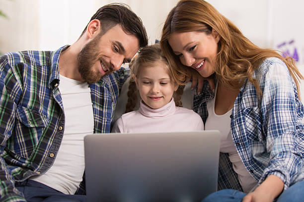 istock Young family is   enjoying watching something  on laptop screen. 527224946