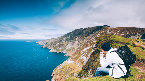 Hiker enjoys view of Slieve League mountain on the Atlantic coast