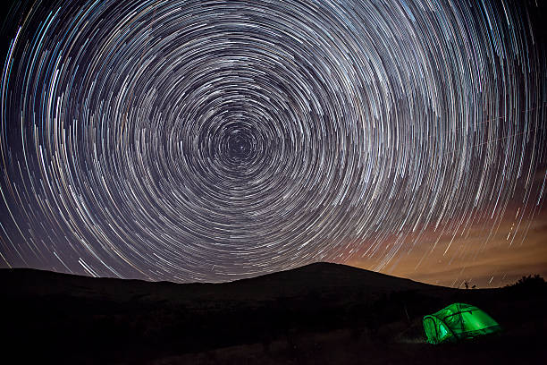 istock Star trails, mountain and tent 527226316