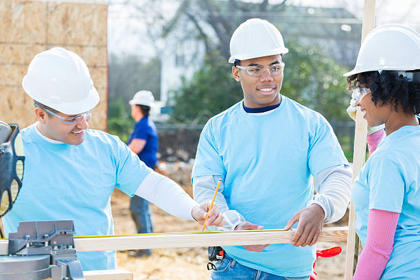 istock Male and female construction volunteers work on building project 527228436