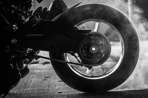 stunt rider ride and burn wheel tire with engine power