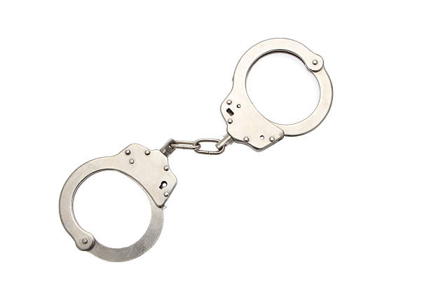 handcuffs handcuffs on white background handcuffs stock pictures, royalty-free photos & images