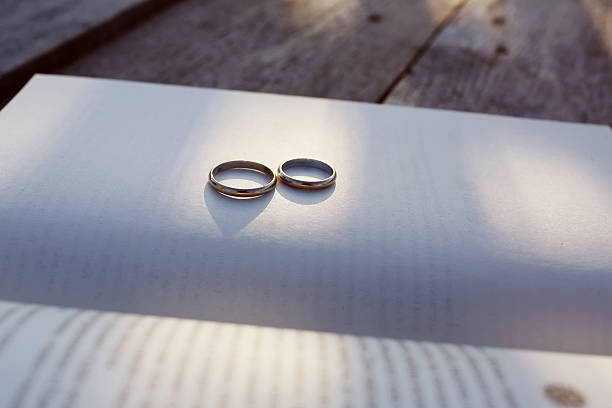 istock Gold wedding rings on the book 527234720