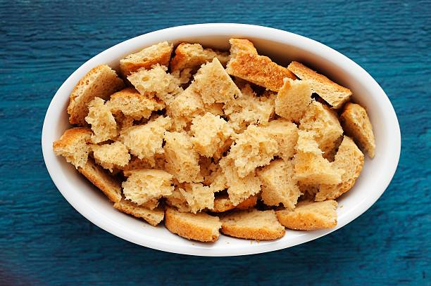 istock Panettone torn in pieces for homemade pudding on navy blue 527234998