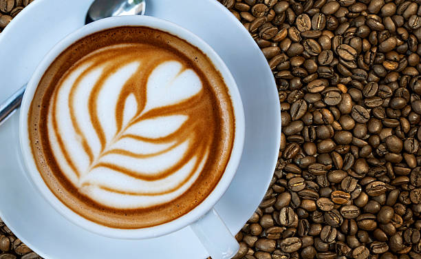 istock Cup of espresso drink on left with coffee bean background 527235472