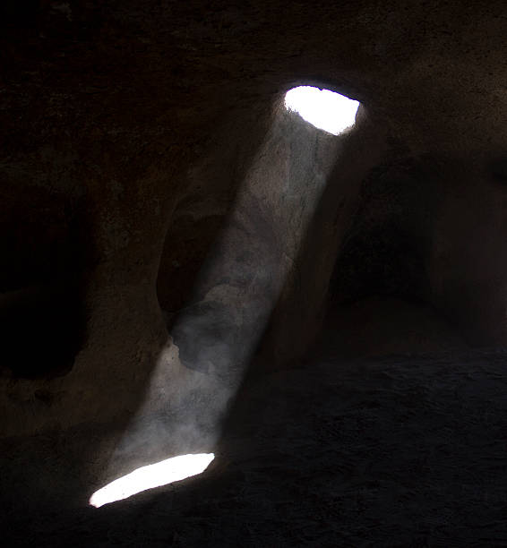 Sunbeam reaching inside of cave in Cappadocia, Turkey. Image taken inside of a cave in Cappadocia and a natural light reaching into the inside of cave. Square composition.
