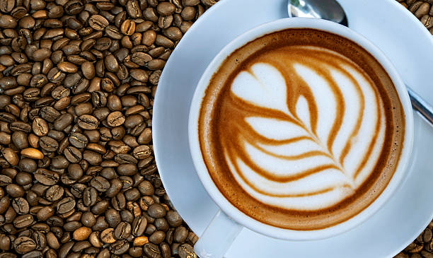 istock Cup of espresso drink on right with coffee bean background 527236152