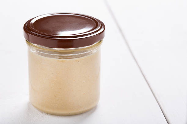 Natural diy homemade tahini paste Homemade DIY natural vegan very healthy tahini paste made of sesame seeds in a glass jar on a wooden table heatlhy food stock pictures, royalty-free photos & images