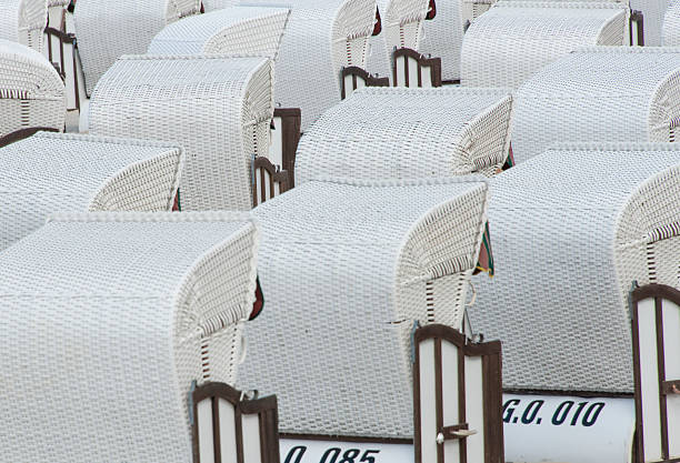White wicker chairs on a beach