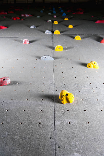 istock Artificial climbing wall with a variety of holds 527236426