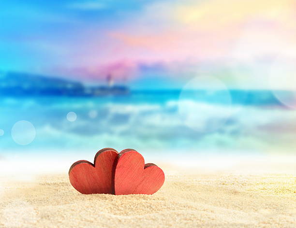 istock Two red hearts on the summer beach. 527237922