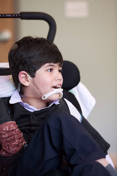 istock Disabled  boy smiling and relaxing in wheelchair 527238079