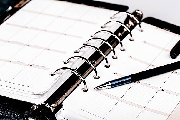 istock Personal organizer or planner with pen on white background 527239492