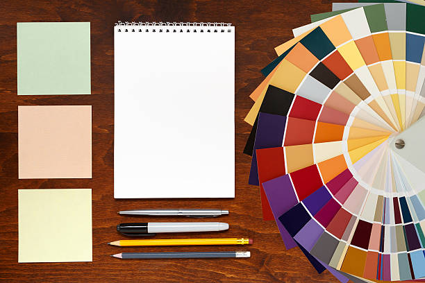 istock Color palette guide on the wooden background and notepad 527239786