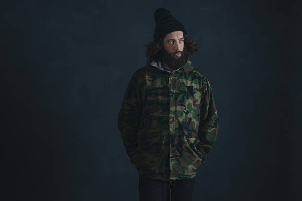istock Vintage man with beard and long hair wearing camouflage jacket. 527241164
