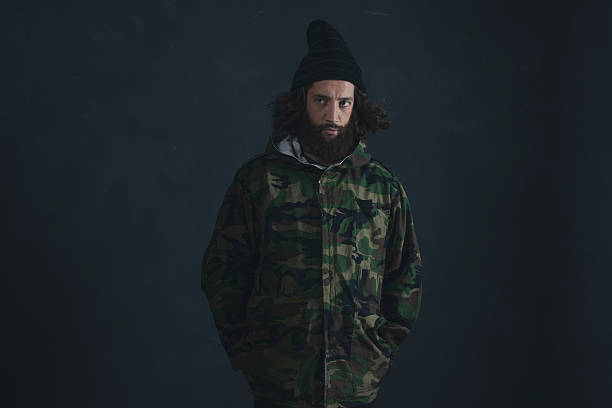 istock Vintage man with beard and long hair wearing camouflage jacket. 527241186