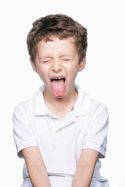 Boy making silly face Boy making silly face awful taste stock pictures, royalty-free photos & images
