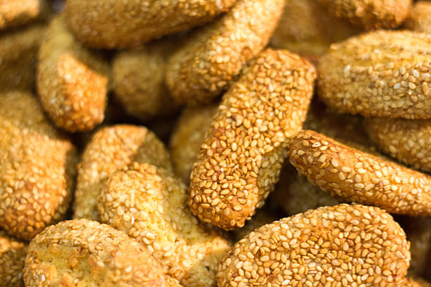 Pile of typical Italian (Sicilian) sesame seed cookies/biscotti, with selective focus.