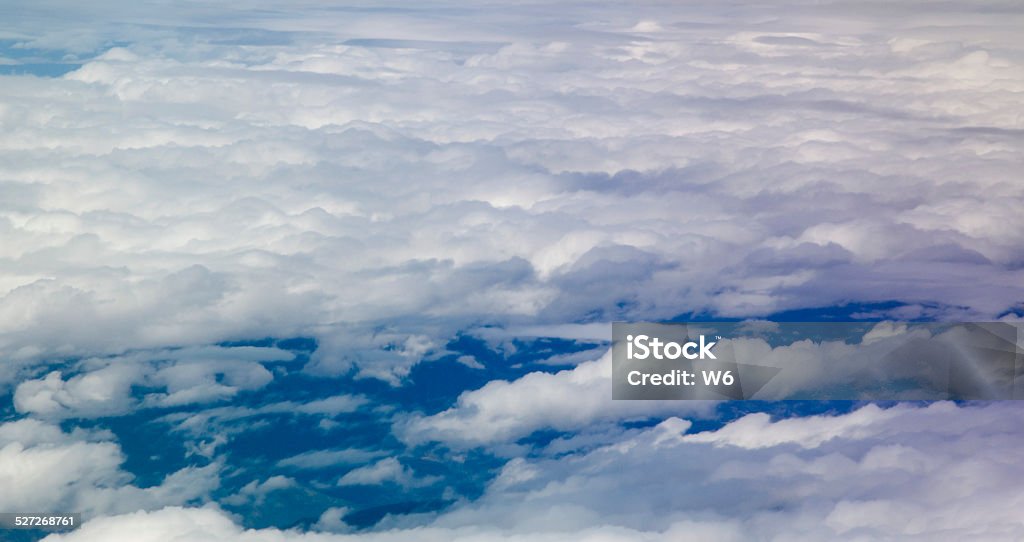 Cloudscape Clouds and sky as seen through window of an aircrafthttps://lh4.googleusercontent.com/-Hp9YHQTtoGI/VMUQvR4hOmI/AAAAAAAAA_w/B7Hzpqm7xGk/s380/banner_Cloudscape.png Above Stock Photo