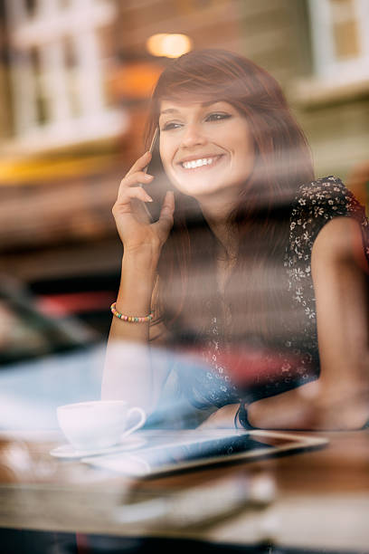 istock Young smiling woman talking on the phone 527270701