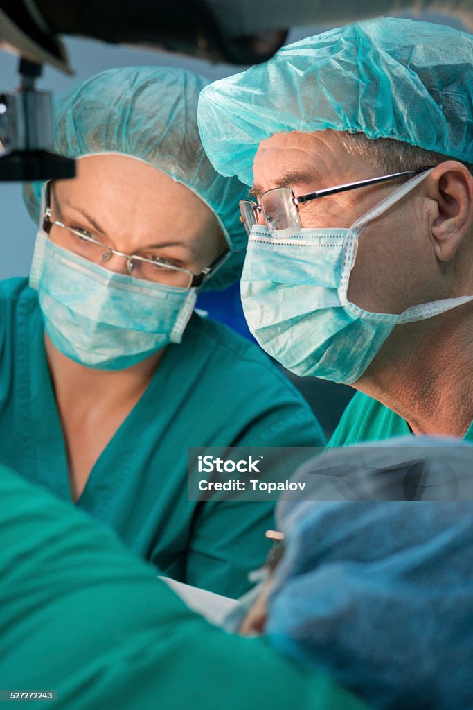 Teamwork Medical team in operating room during surgery Accidents and Disasters Stock Photo