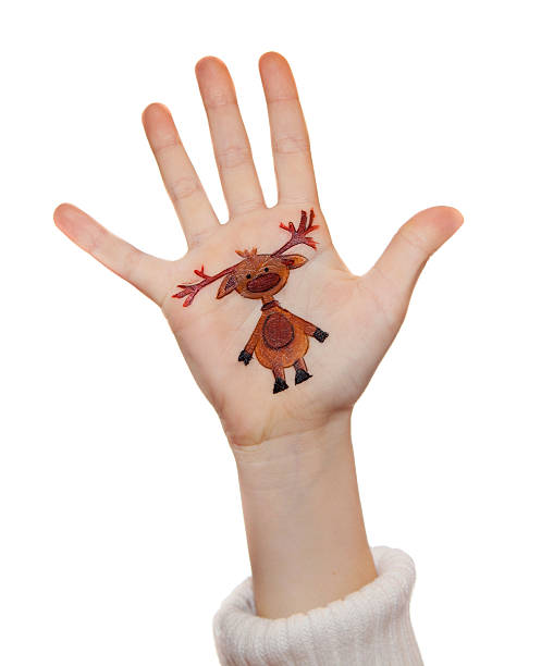 Kid's hands with painted Christmas symbol