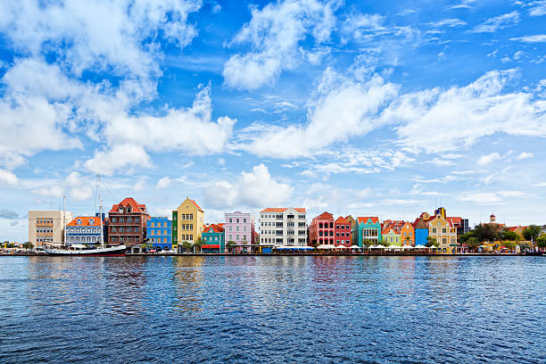 Willemstad, Curaçao - Handelskade with colorful facades Historic houses with colorful facades at waterfront of Willemstad, Curaçao curaçao stock pictures, royalty-free photos & images