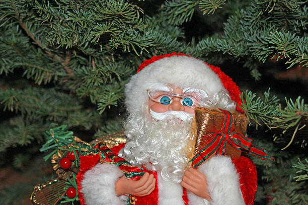 istock Santa Claus against a fir Christmas tree 527273681