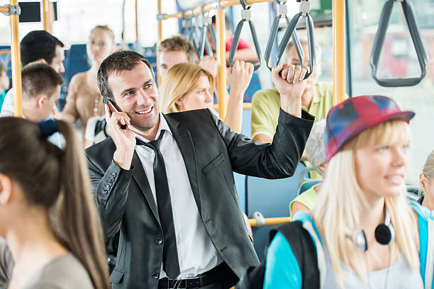 istock Mid adult man talking on phone while commuting by bus. 527274423