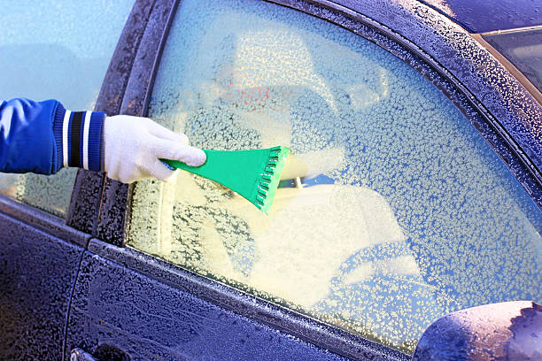 istock scraping the windshield of a car 527275957