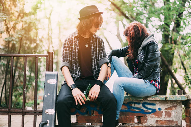 Retro image of young trendy couple holding hands. Main focus on hands.