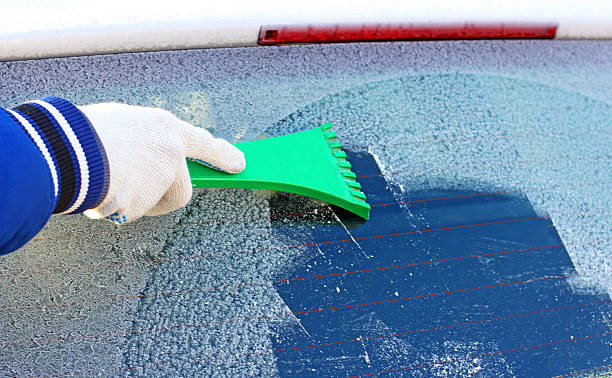 istock scraping the windshield of a car 527276455