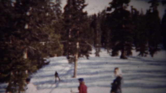 1940: Winter snow skiing T-bar chairlift ride up mountain.