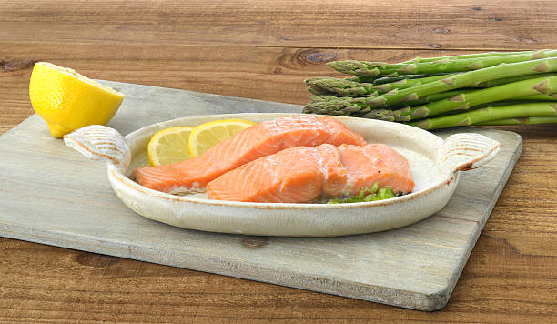 Salmon with lemon and asparagus stock photo