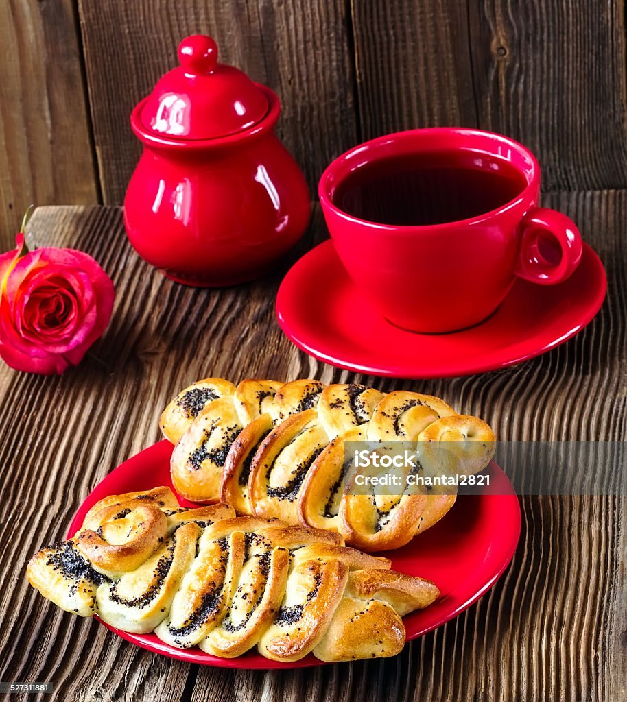 wattled rolls with poppy wattled rolls with poppy on a red plate on a brown wooden background Baked Stock Photo