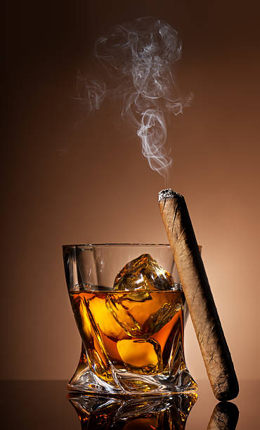 istock Glass of whiskey and cigar 527312223