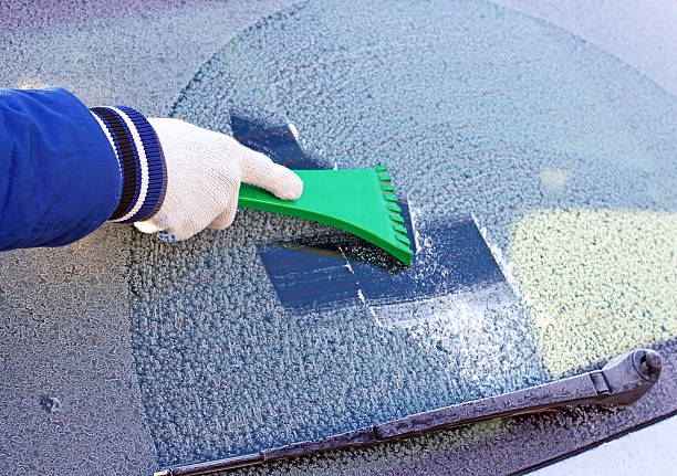 istock scraping the windshield of a car 527312471