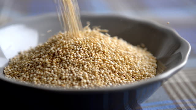 Quinoa flowing into a bowl