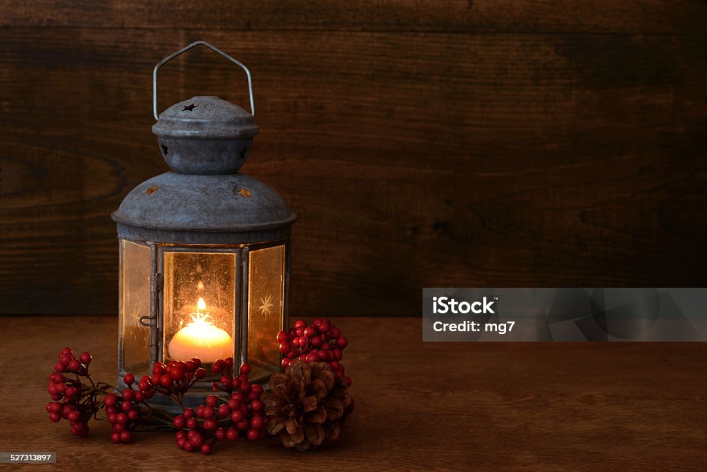 antique lantern with red berries antique lantern with red berries on wood  Antique Stock Photo